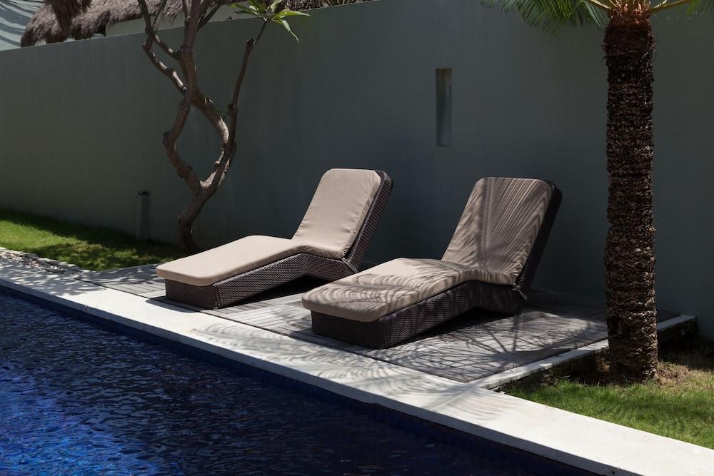 G Hotel Gurney George Town Exterior photo Sunloungers by a swimming pool